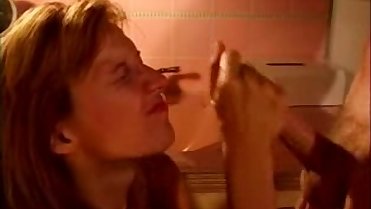 Cute MILF jerking him to take a cumshot on her face